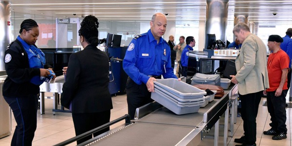 TSO's helping passengers at security checkpoint.