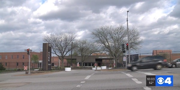 Image of government building in the distance with cloudy sky above. 