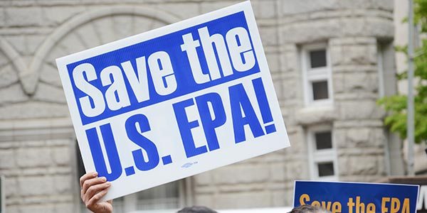 Rally-goes holds sign that says Save the U.S. EPA during a demonstration in front of the US EPA headquarters in Washington, DC. 