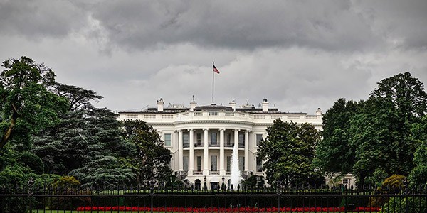 Image of the White House with a gray sky in the background.