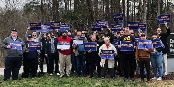 Group of AFGE activists hold rally signs in support of EPA Worker Bill of Rights outside of an EPA facility.