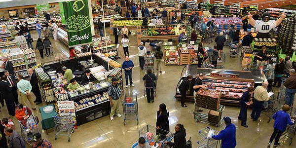 Shoppers milling about a military commissary store.