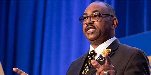 Image of National President Kelley speaking at a podium.