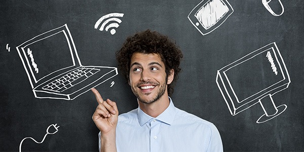 Man centered in graphic. He's looking up around him is a chalkboard background with computer parts drawn in chalk. 