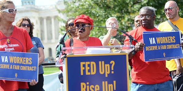 Alma Lee speaking at a podium at a rally