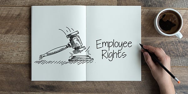 Notebook open on desk. On the page is the text Employee Rights