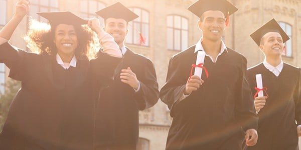 People standing together with graduation caps and gowns