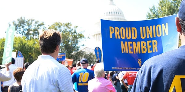 Rally goer holding sign that reads proud union member