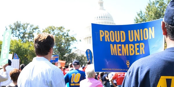 Rally goer holding sign that says proud union member