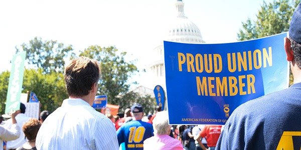 Rally goer holding sign that says Proud Union Member