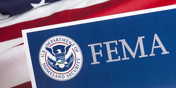 FEMA logo with American Flag in the background