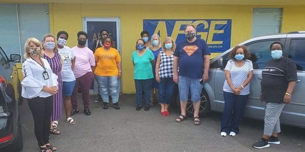 Group of AFGE members standing outside of a union hall