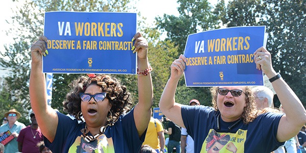 Two AFGE VA members holding signs at rally outside of US Capitol