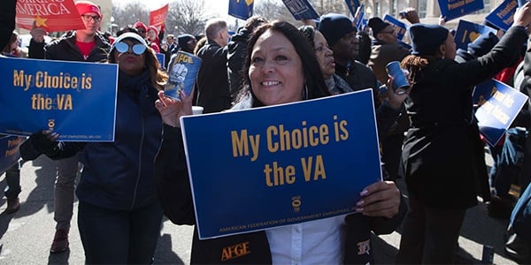 Woman holding sign at a rally that reads My Choice is the VA