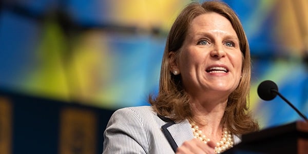 Liz Shuler speaking at a podium