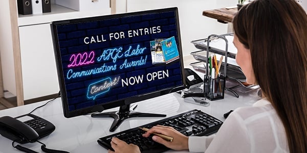 Person sitting at computer looking at communications contest graphic