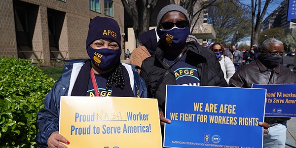 Two members holding rally signs