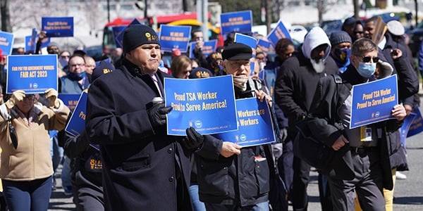 Members holding TSA rally signs