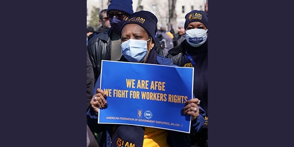 Member holding we are AFGE sign