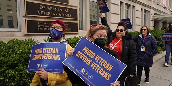 VA rally goers holding signs