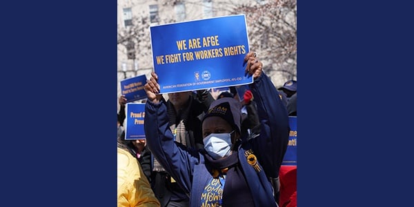 AFGE member hold signs