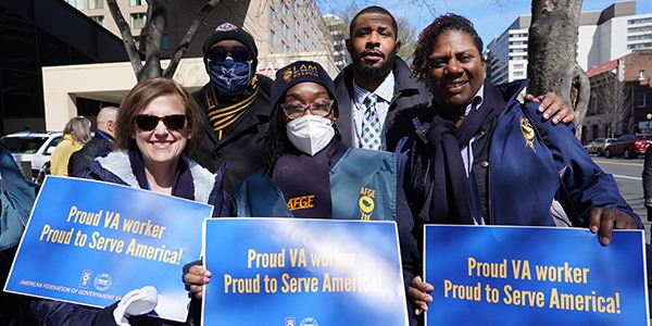 Group of AFGE activists holding rally signs