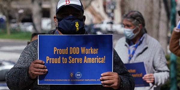 AFGE member with DoD sign