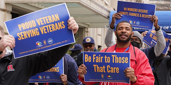 Members holding signs at VA rally