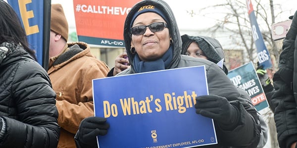 Rally-goer holding sign that says Do What's Right