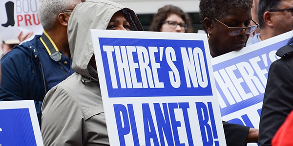 Rally-goer holding sign that says There's no planet b