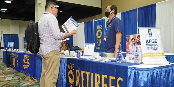 Activist visits the AFGE Retiree table at the convention