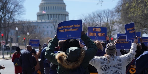 AFGE members hold signs near the Capitol