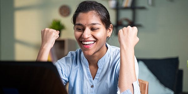 Excited person in front of a computer. 