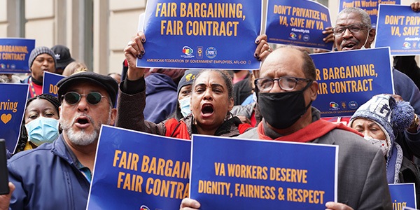 AFGE members hold signs