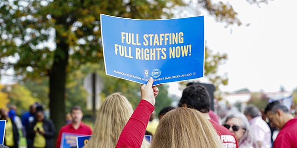 AFGE member holding rally sign.