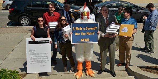 Members and staff at a food safety event with a person in a chicken suit