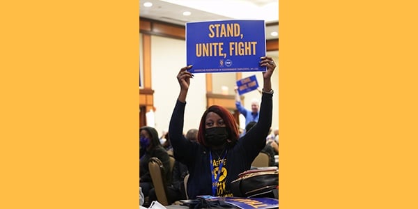 Member holding sign