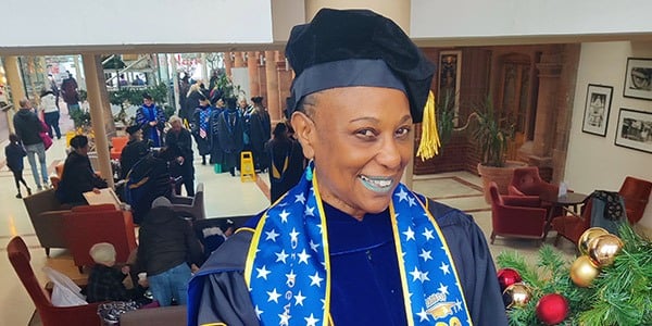 AFGE Local 1061 President Dewanda Mitchell wearing a cap and gown.