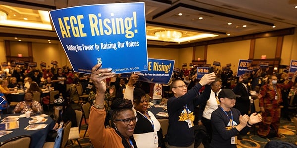 AFGE members at conference holding signs