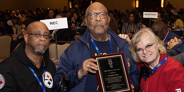 Don Fowler (center) pictured with two AFGE members