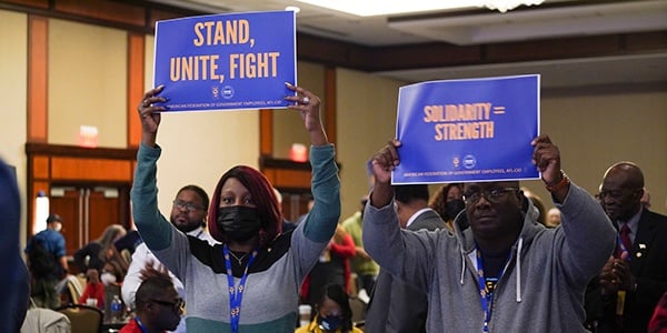 Members holding signs