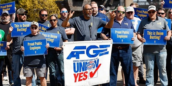 Members holding signs