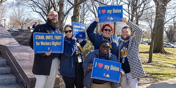 Members at a rally with signs