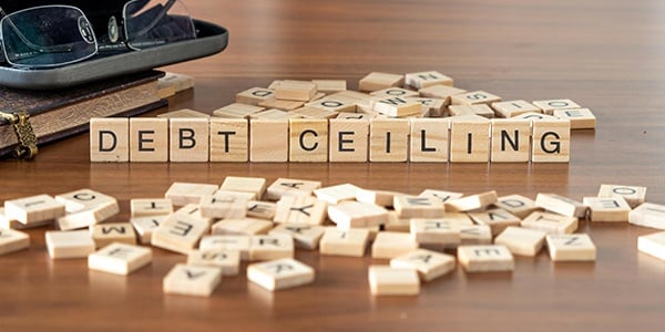 Scrabble game tiles spelling Debt Ceiling