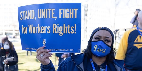 AFGE activist with rally sign