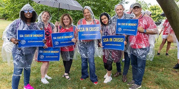 AFGE SSA activists hold rally signs