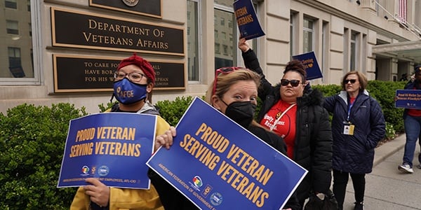 AFGE VA activists hold rally signs