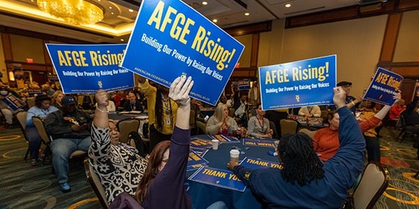 AFGE activists hold rally signs