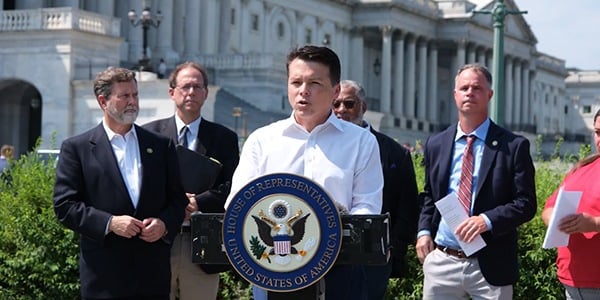 Lawmaker speaking at a podium