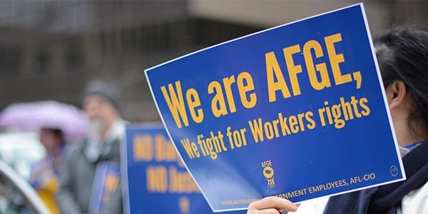 AFGE rally sign that says We are AFGE, We fight for workers' rights